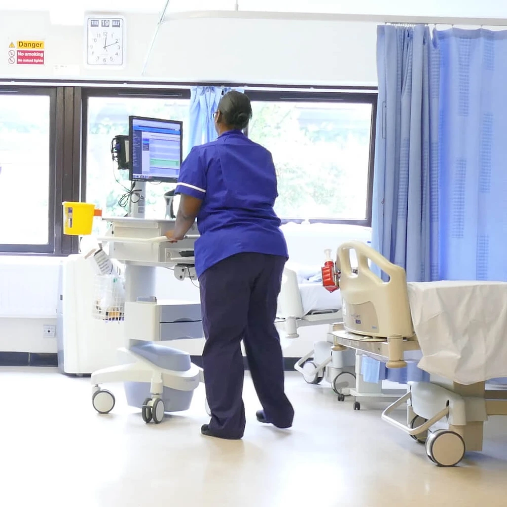 Nurse pushing an Exura EPR / ePMA trolley